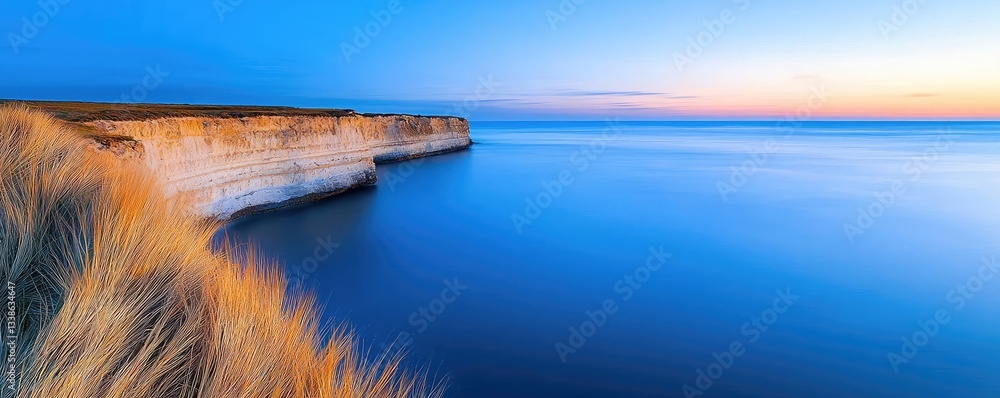 Poster seaside cliffs landscapes idea. serene coastline at sunset with calm waters and sandy cliffs reflect