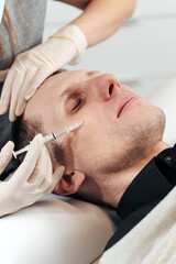 Master performs facial mesotherapy on a man