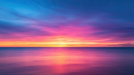 Fototapeta premium Sunset over ocean landscapes idea. Stunning sunset over calm waters with vibrant hues of pink and blue.