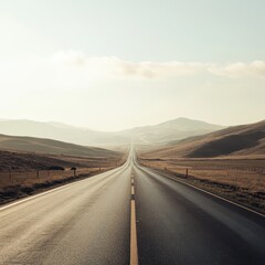 Fototapeta premium Serene Open Road Stretching Into Distant Mountains at Sunrise