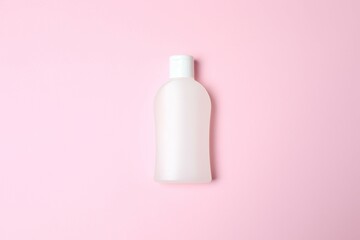 Natural cosmetic products. Cosmetic bottle a pink background, top view