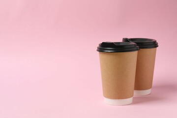 Paper cups with plastic lid on light background. Coffee to go