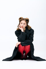 Fototapeta premium Stunning young woman in stylish attire exudes confidence and allure in a minimalistic setting