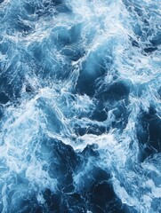 Fototapeta premium Aerial View of Deep Blue Ocean Waves Crashing and Forming White Foamy Patterns in a Dynamic Seascape