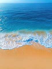 Serene aerial vista of turquoise ocean waves gently washing onto golden sandy beach creating a peaceful coastal scene