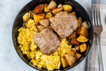 sausage patties with scramble eggs and home fries