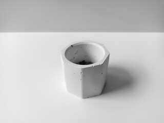Mini cement pot for white decorative flowers, isolated on white background. closeup