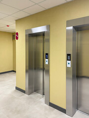Lobby of a new residential building featuring sleek elevators and modern interior design. © Rafail