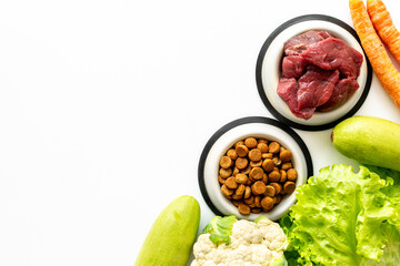 Bowls with healthy pet food and ingredients, top view