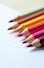 Obraz premium Colored pencils resting on graph paper ready for creative drawing