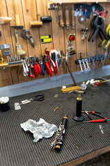 Luthier repairing clarinet in workshop with tools