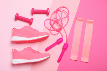 Different sports equipment and sneakers on color background, flat lay