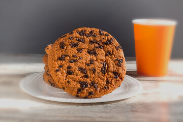 Breakfast with cookies on a red table. Symbolizes morning enjoyment and leisurely moments of relaxation. Warm sunlight falls on the cookies, highlighting their texture.