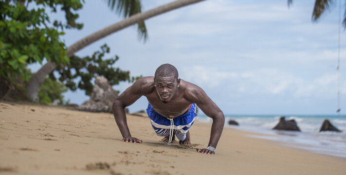 Black Man Doing Push-Ups on Caribbean Beach with White Smartwatch