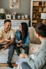 Young couple discussing with their psychologist during therapy session