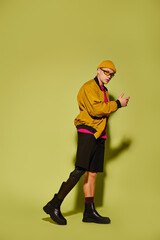 Handsome young man showcasing stylish attire with a prosthetic leg in studio setting