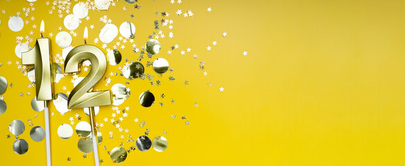 Golden candle number twelve on yellow background. Birthday card with lettering 12. Anniversary...