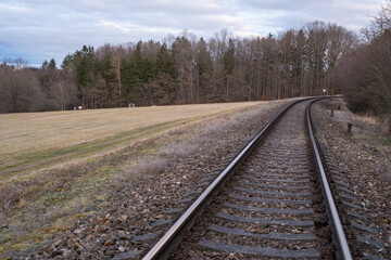 Fototapeta premium Curved Railway Tracks in Rural Landscape