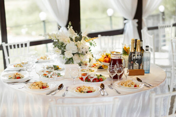 beautiful set of plates with kitchen utensils with food on white tablecloth	