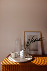Close-up of the aesthetic details of the home interior. Ceramic tray on a wooden chest of drawers in the bedroom