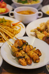 Indonesian satay, captured on March 17, 2025. Grilled skewered meat coated in rich spices and served with savory peanut sauce, creating a flavorful and authentic dish