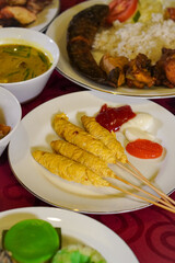 Indonesian satay, captured on March 17, 2025. Grilled skewered meat coated in rich spices and served with savory peanut sauce, creating a flavorful and authentic dish