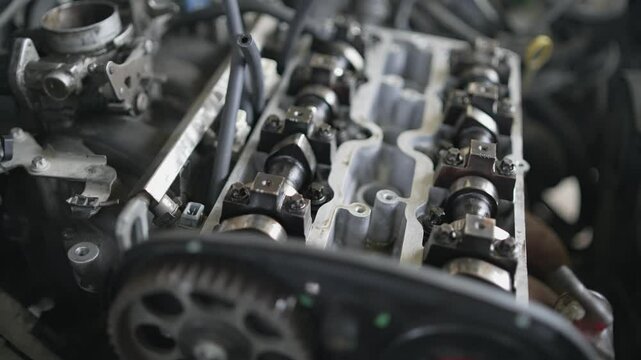 Close-up of a car engine camshaft and chain during mechanical inspection