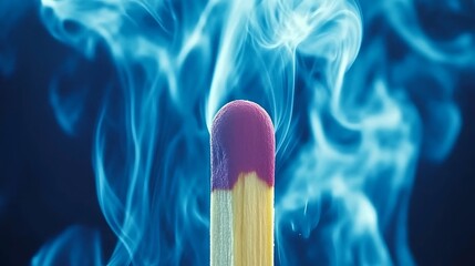 Lit matchstick with smoke in dark background, arson