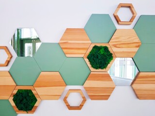 Wall decor in the form of hexagonal panels with mirror and artificial moss