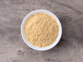 Farofa, typical brazilian manioc flour side dish over wooden table