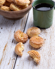 Samanta, typical brazilian sugar covered biscuit with coffee over wooden table