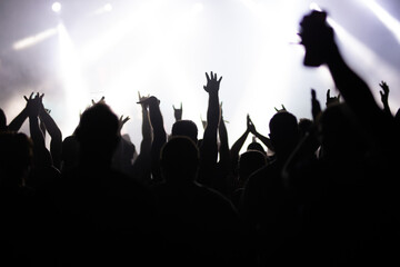 Crowd at concert and blurred stage lights.