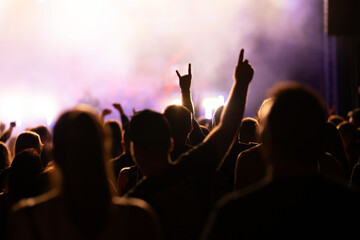 Crowd at concert and blurred stage lights.