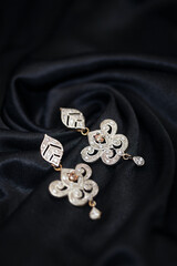 Close-up of a beautiful designer Diamond earrings isolated over a black background.