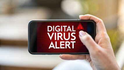 Virus outbreak and containment concept. Person holding smartphone displaying digital virus alert message, conveying urgency and concern.