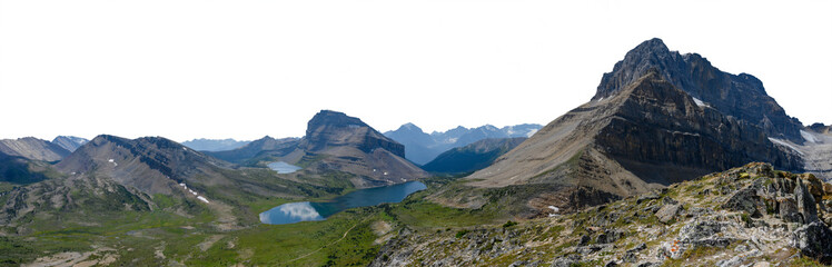 Panorama of Rocky Mountain scene with small lake large mountain distant blue hills and transparent sky. Banff Canada