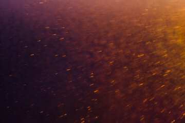 Blurred bokeh light sparkle on golden black background