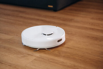 Wireless robotic vacuum cleaner is in the domestic room