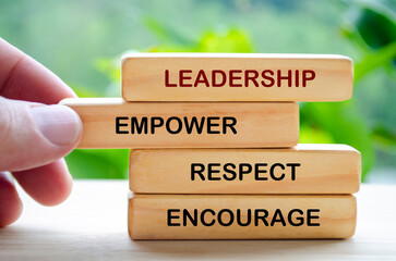 Leadership, empower, respect and encourage text on wooden blocks. Leadership concept