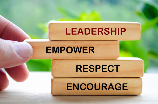 Leadership, empower, respect and encourage text on wooden blocks. Leadership concept