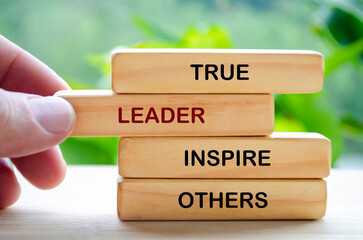 True leader inspire others text on wooden blocks. Leadership concept