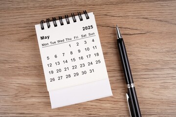 May 2025 notepad calendar on the table and pen
