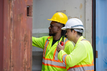Engineer man Team in Safety Gear Inspecting Containers Box at Industrial Site, Container Yard...