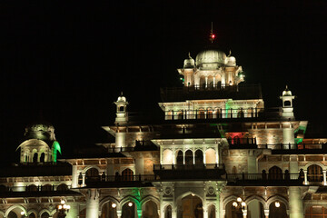 A vibrant and colorful nightscape of Albert Hall Museum, illuminating the Jaipur cityscape in Rajasthan, India.