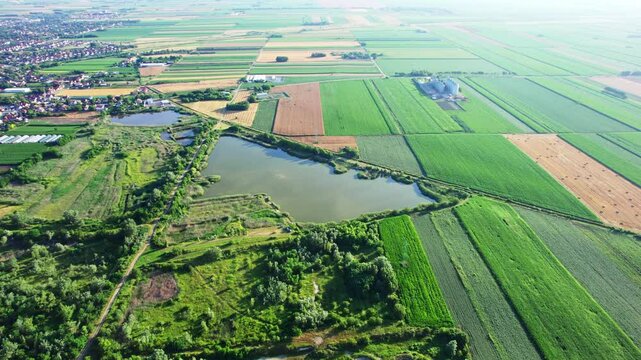 Exploring expansive fields and serene waters in a rural landscape during a sunny day