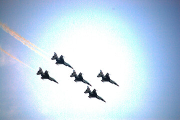 Military aircraft team flying wingover for show thai people foreign travelers and family and child in National Children Day at Don Mueang Royal Thai Air Force on October 10, 2009 in Bangkok, Thailand
