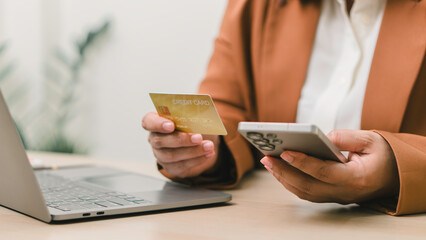 Online payment and digital banking concept. Woman using smartphone and credit card for internet purchases, illustrating e-commerce transactions, secure mobile shopping, and financial technology.