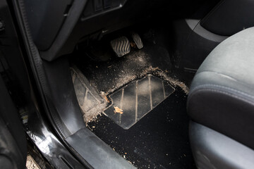 Sandy and dusty car floor mat by the pedals, showcasing the need for automotive cleaning. Great for...