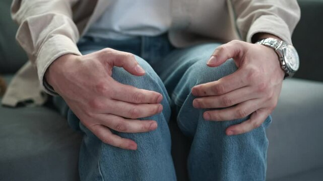 The man has a strong tremor in his legs.
The man is experiencing severe stress.
Tremors in the legs from nerves.
Psychological state and strong anxiety
