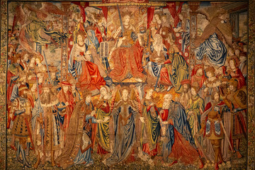 A large, intricate tapestry featuring a diverse group of people on it